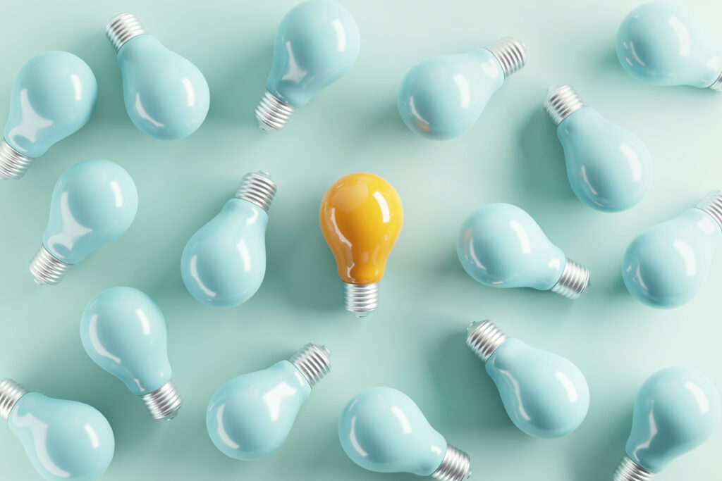minimal idea of yellow light bulb surrounded with blue bulbs on pastel background. 3d rendering. idea creative concept. copy space.